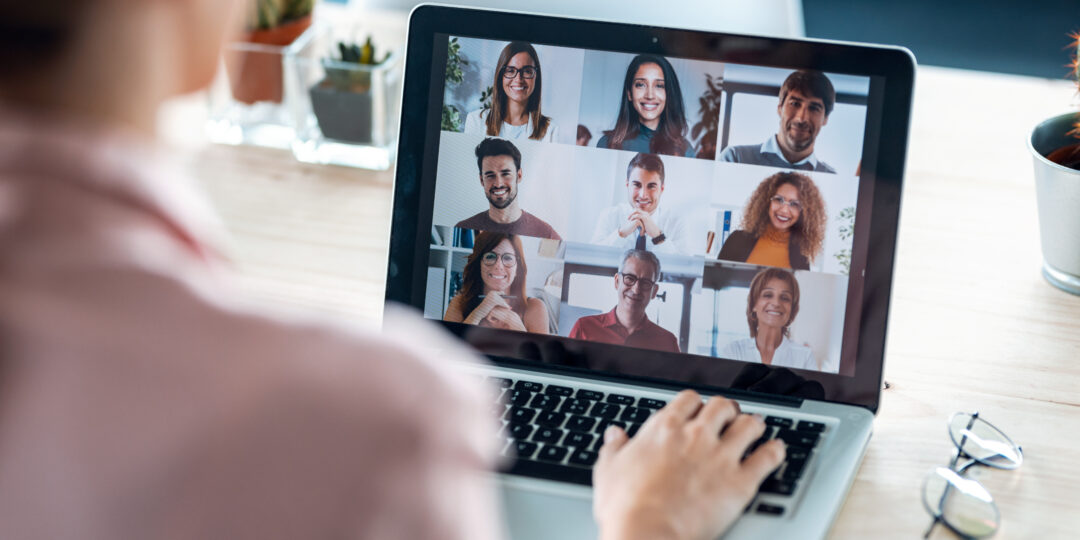 Female employee speaking on video call with diverse colleagues o