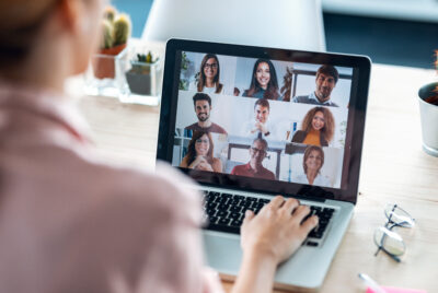 Female employee speaking on video call with diverse colleagues o